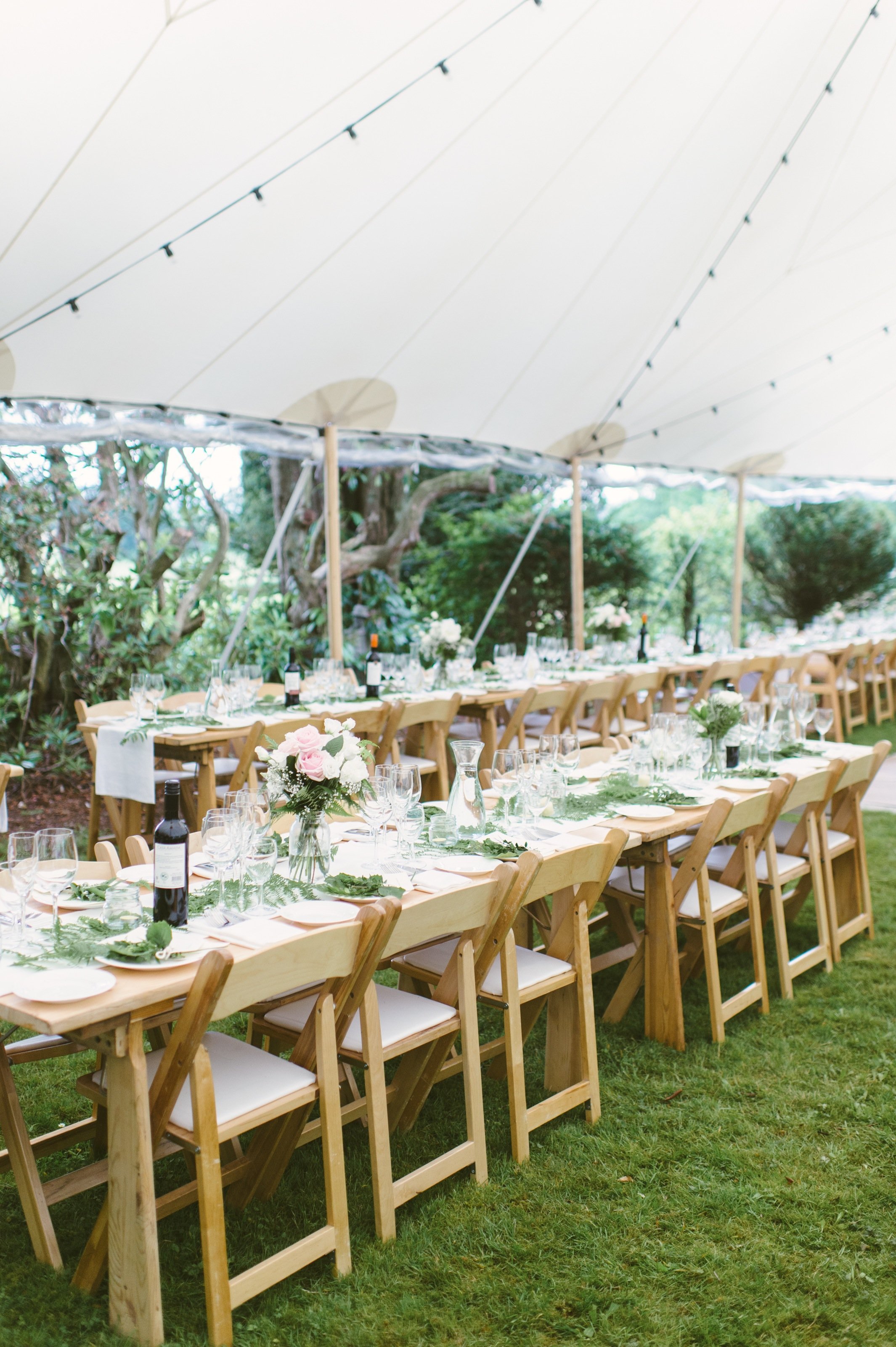 A Sperry tent with beautiful folding chairs and solid wood tables Sperry_Nevin_paperantler