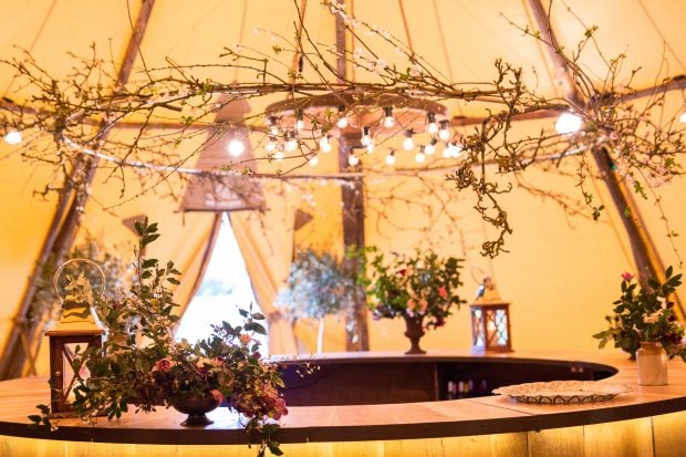 Budding blossoms and festoon adorned Cartweel adds interest and adornment above the Circular Oak Bar