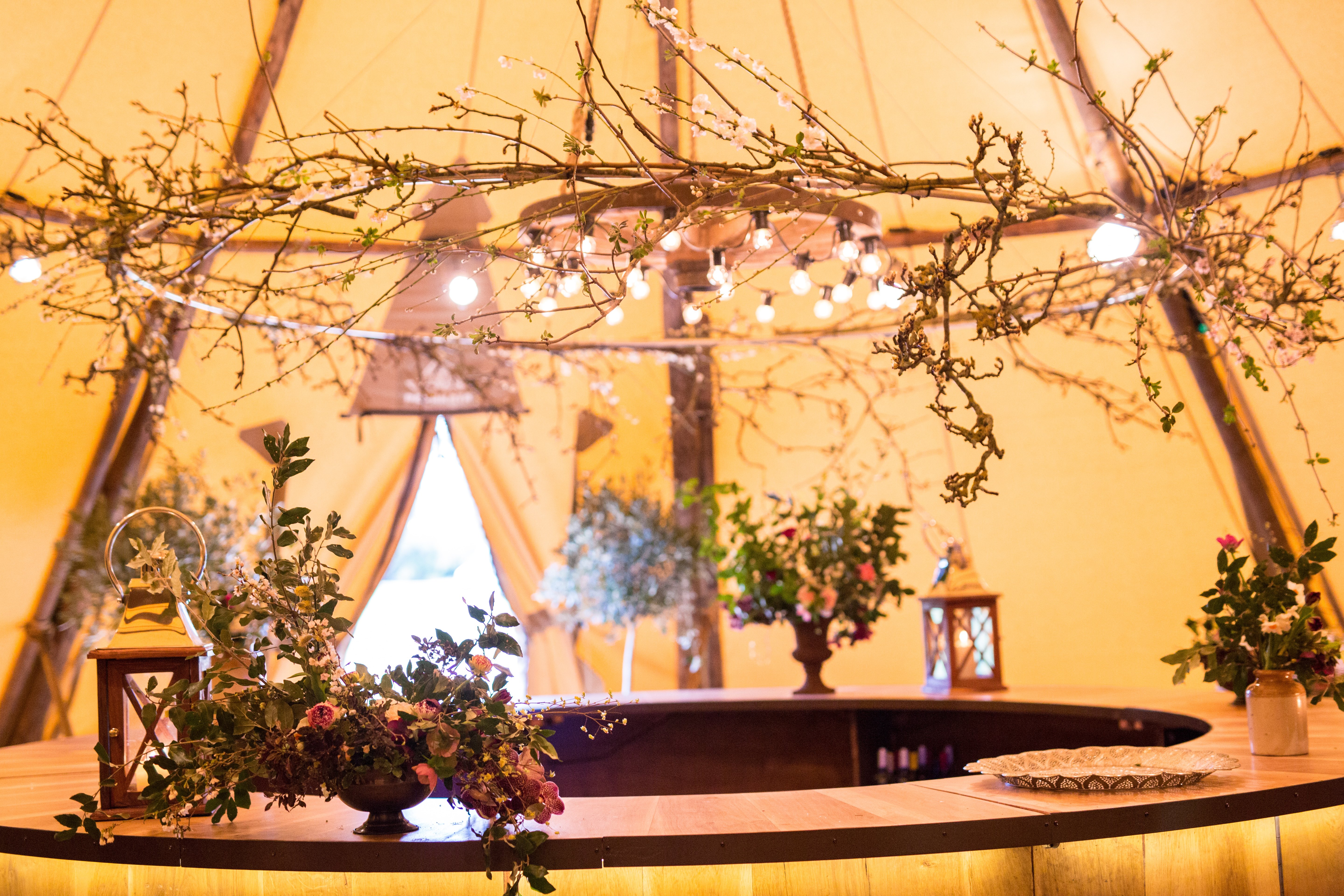 Budding blossoms and festoon adorned Cartwheel above the Circular Oak Bar Budding blossoms and festoon adorned Cartwheel above the Circular Oak Bar
