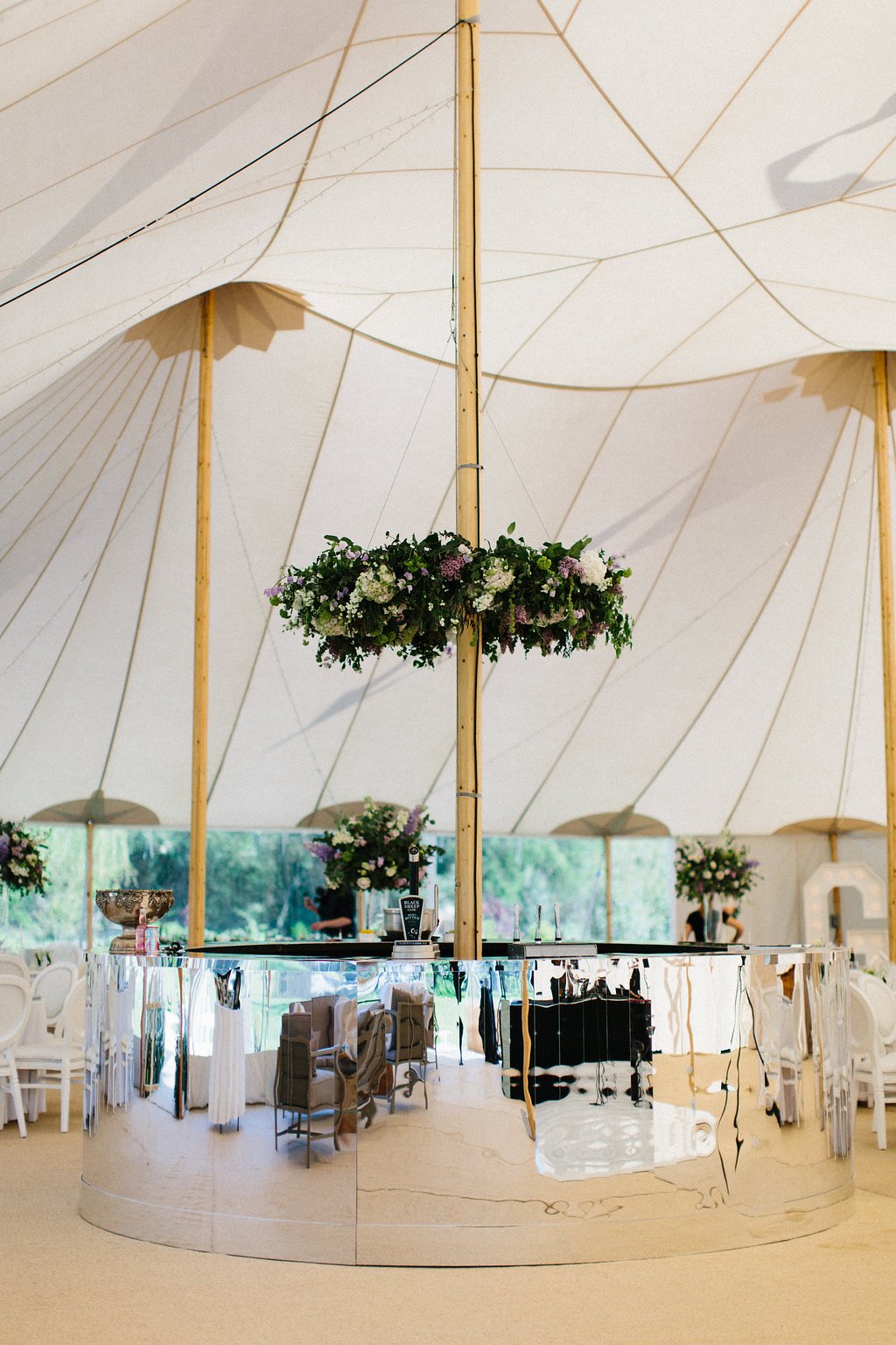 PapaKåta couple Georgina & Steve Sperry Tent Wedding in Barnby Dun, Doncaster captured by Melissa Beattie- Mirrored circular bar by Furniture 4 Events with 1.2m Floral Hoop by Lucy MacNicoll 