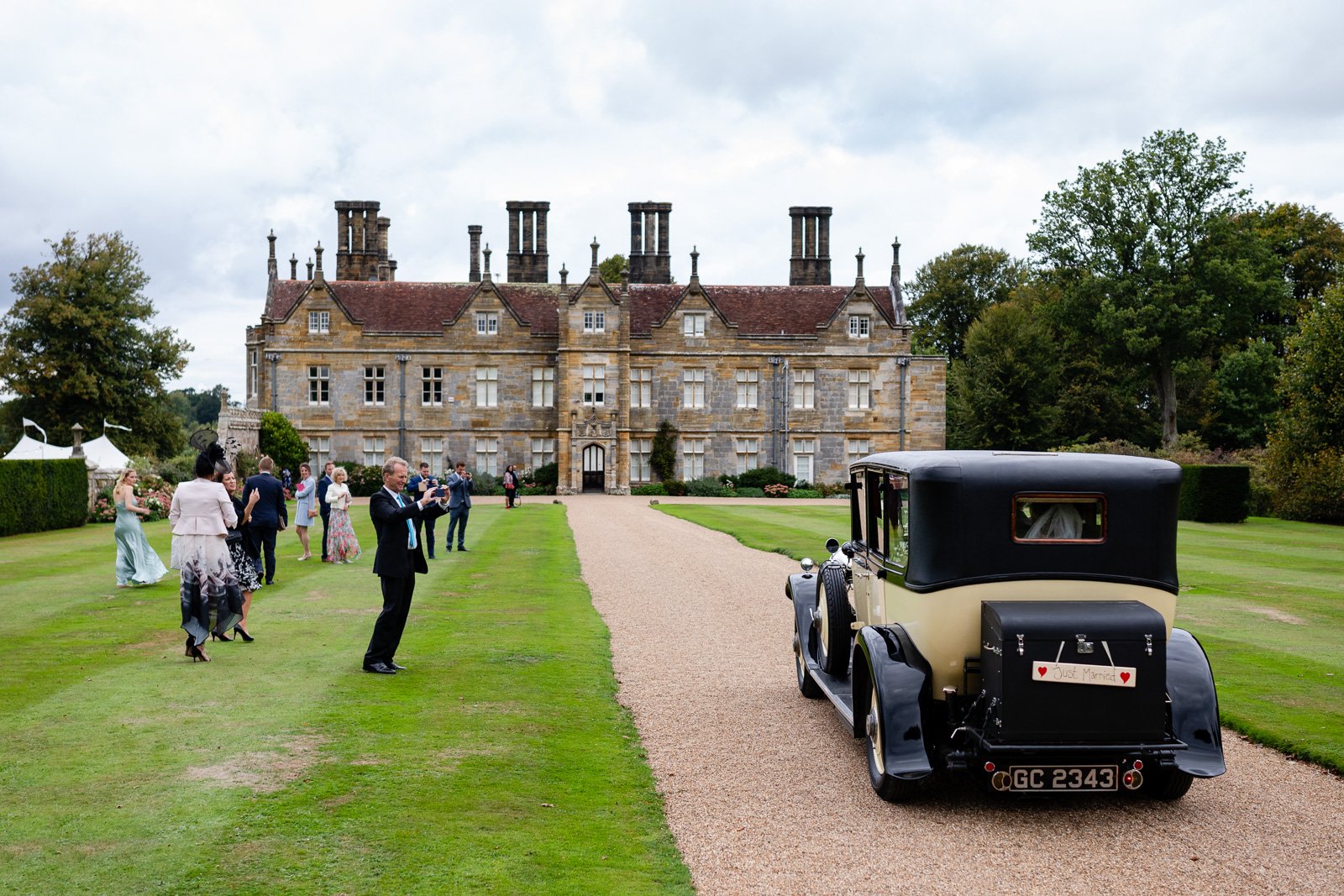 Emily & Ed's PapaKåta Sperry Tent wedding at Buckhurst Park captured by Tony Hart Photography: Wedding car- making an entrance 