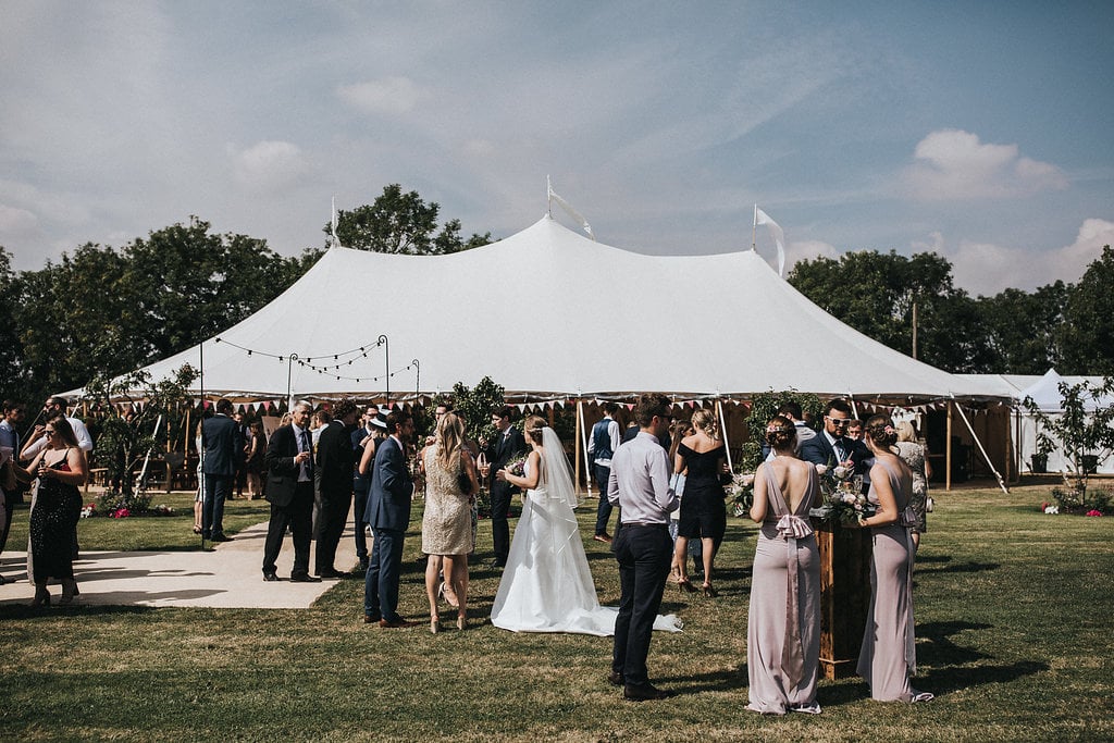 Katie & Thomas' PapaKåta Sperry Tent wedding in Thornborough, Bucks captured by Matt Horan Photography: Sperry Tent exterior wedding guests 