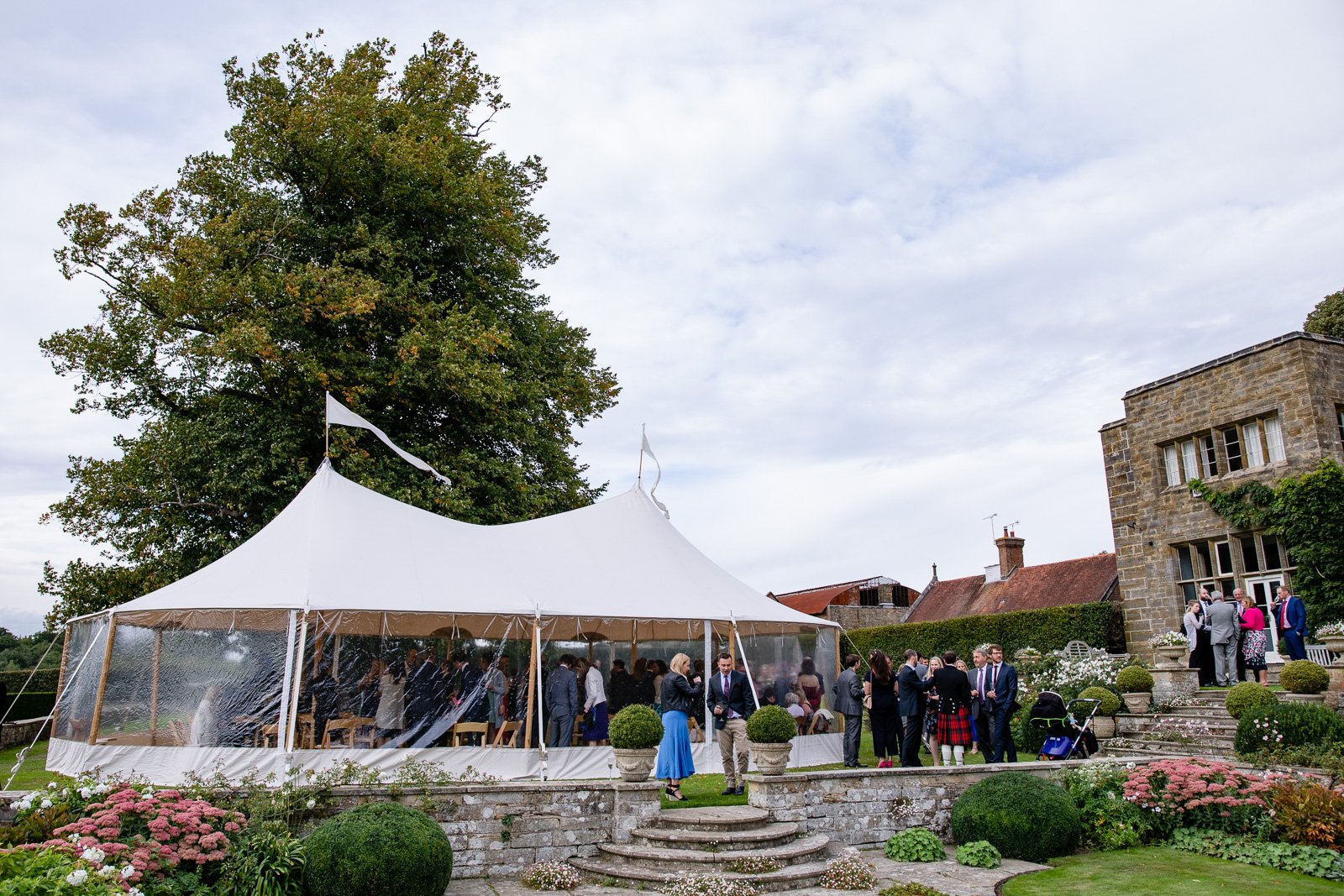 Emily & Ed's PapaKåta Sperry Tent wedding at Buckhurst Park captured by Tony Hart Photography: Wedding Guests, Drink Reception Sperry Tent