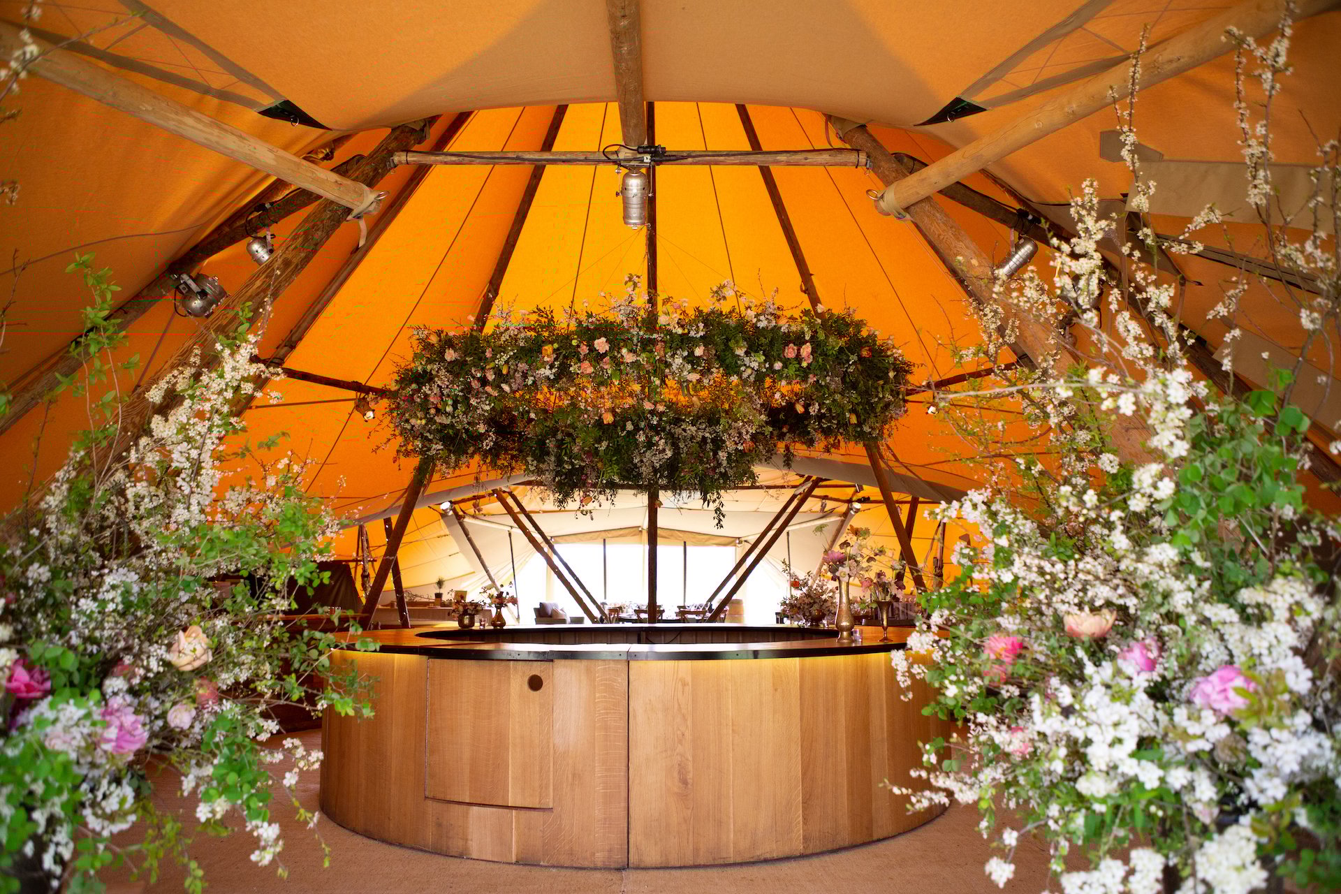 PapaKåta Spring Open Weekend Teepee captured by Lucy Davenport Photography: Circular Oak Bar with Two Tier Floral Hoop by Aelisabet Flowers
