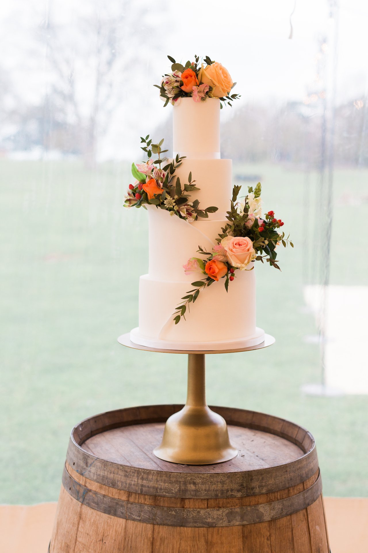 PapaKåta Spring Open Weekend Sperry Tent captured by Lucy Davenport Photography: Wine Barrel Cake Table with Wedding Cake by Cherry Blossom Bakes