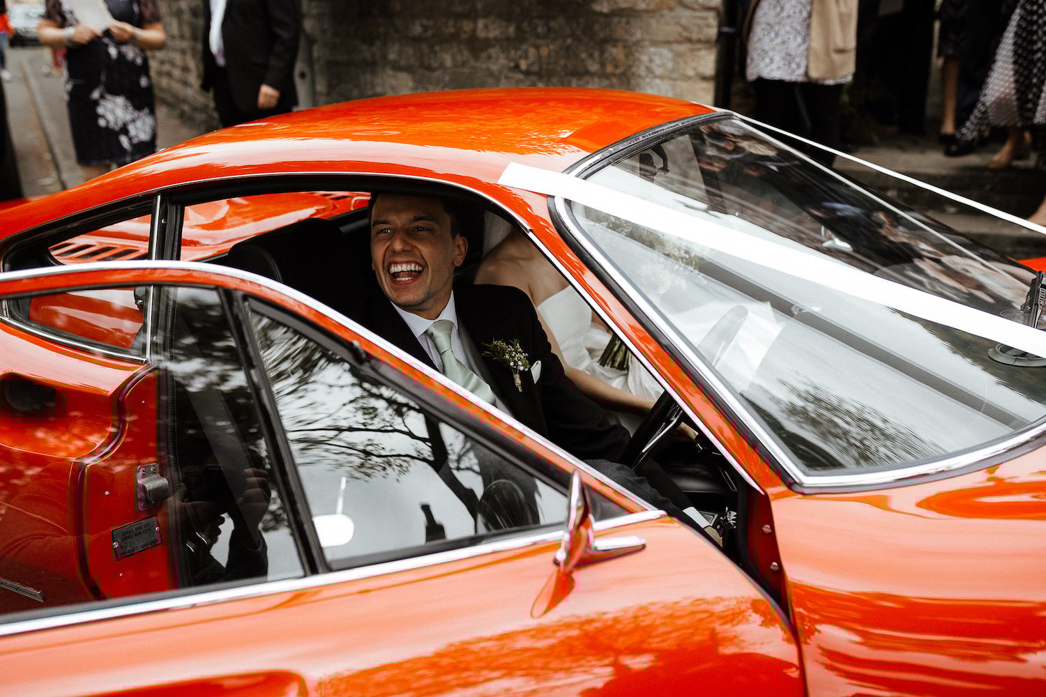 India & Sean PapaKåta Sperry Tent Wedding in Lincolnshire, Yorkshire, Caitlin & Jones Photography; Happy Groom in Car