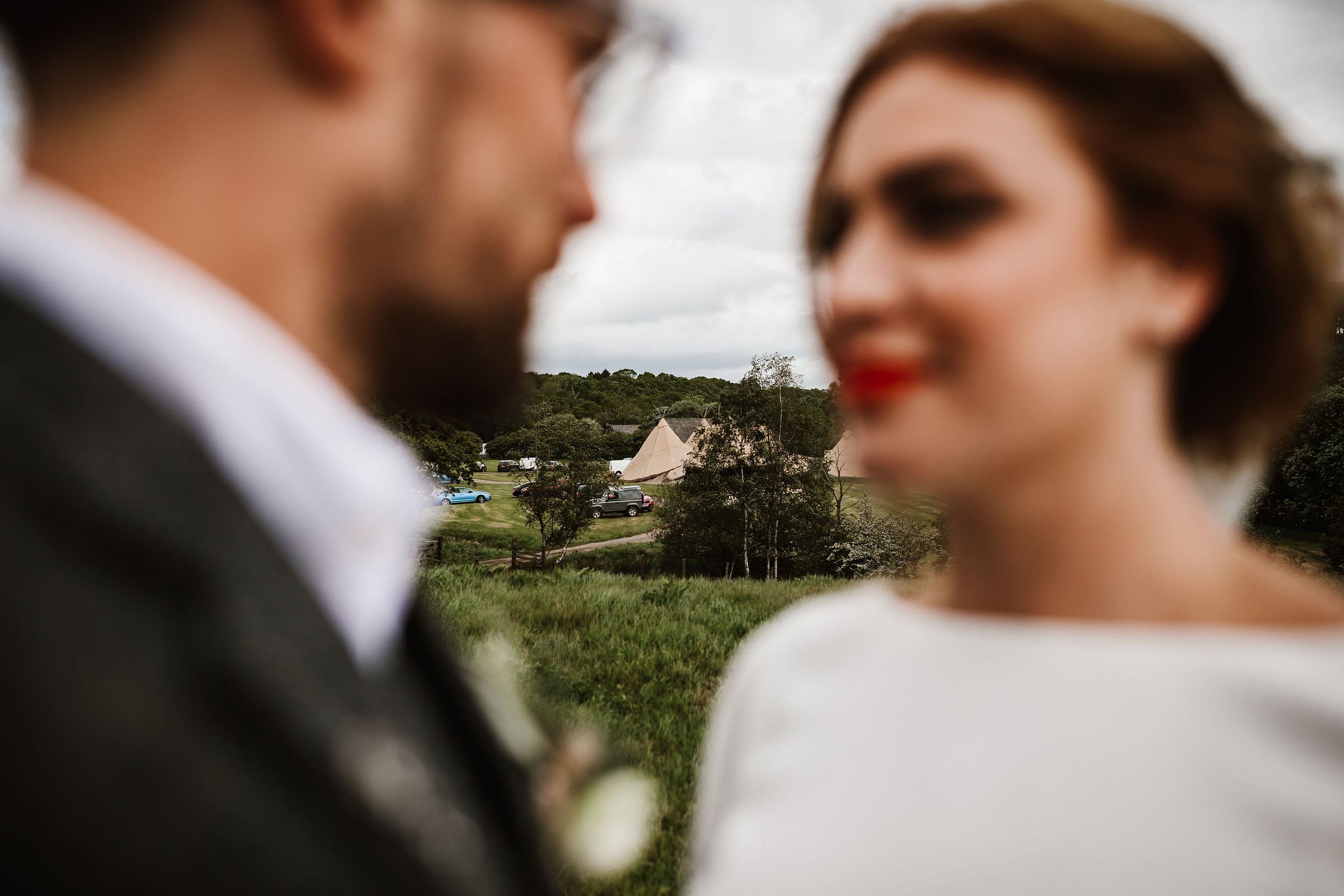 Katie & Jes PapaKata Tipi Wedding, Hidden River Cabins, Ally M Photography; Bride & Groom with Tipi Tent in Background 