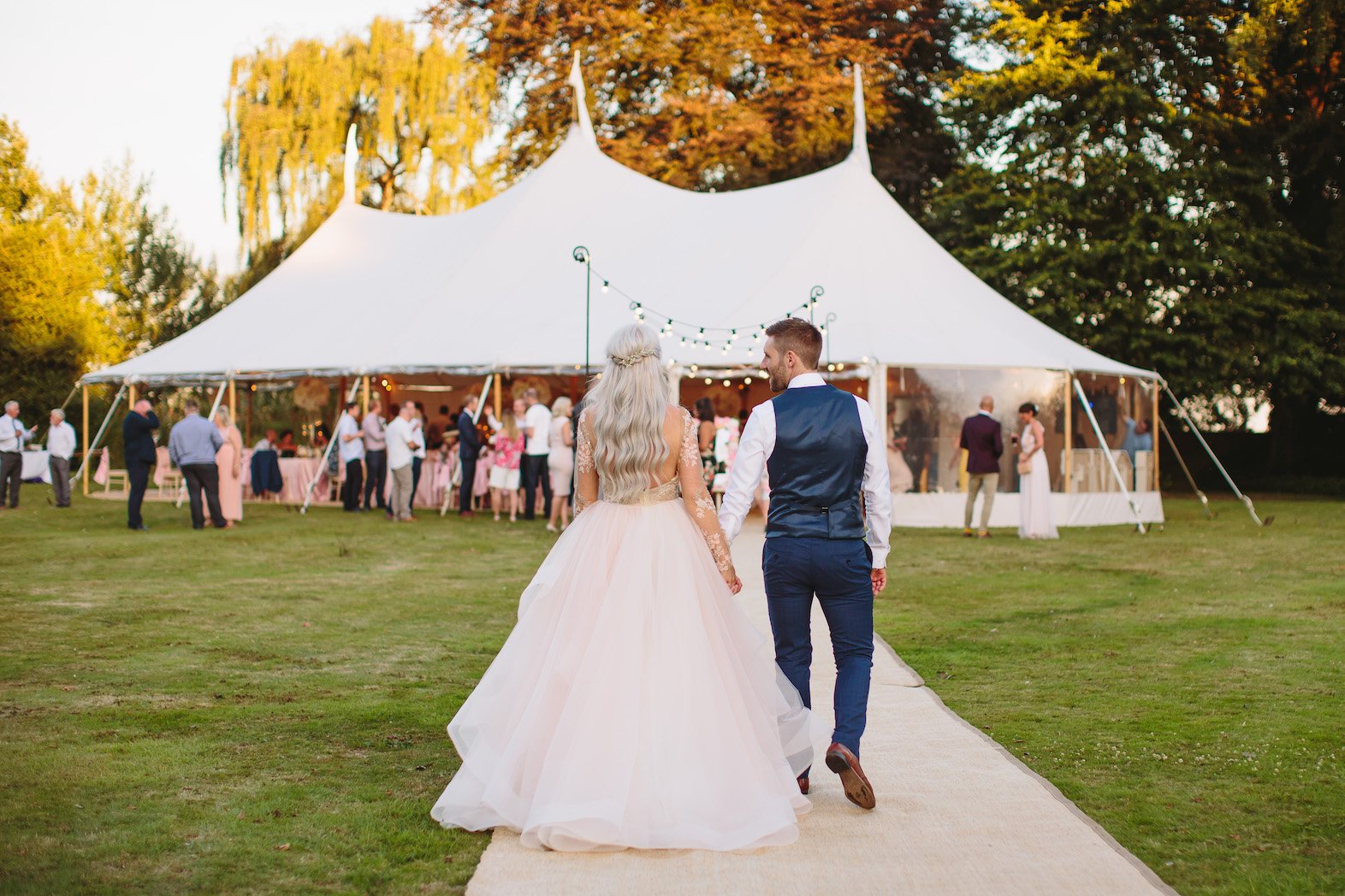 Sarah & Greg PapaKåta Sperry Tent Wedding at Saltmarshe Hall in Howden, Yorkshire. Photographed by Barnaby Aldrick; Bride & Groom Entering The Sperry Tent