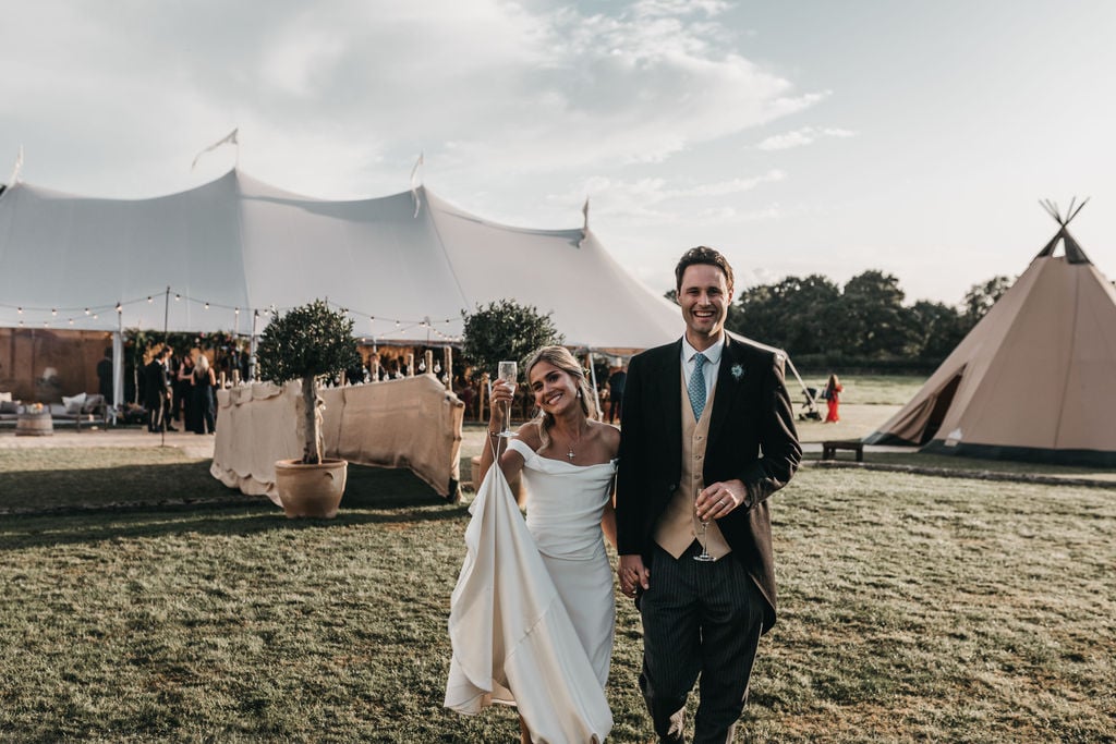 Lottie & Lantos stunning PapaKåta Tipi & Sperry Tent Wedding in Shipley, West Sussex. Photography by Ben Wigglesworth; Happy Bride & Groom