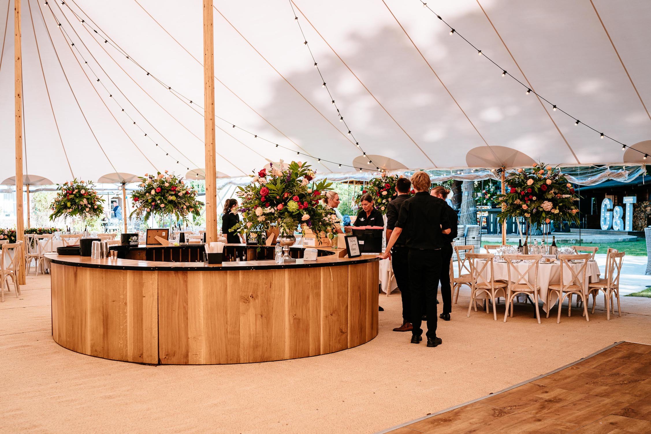 Tara & Garry Beautiful PapaKåta Sperry Tent & Naked Tipi Wedding in Virginia Water, Sarah Legge Photography; Circular Oak Round Bar