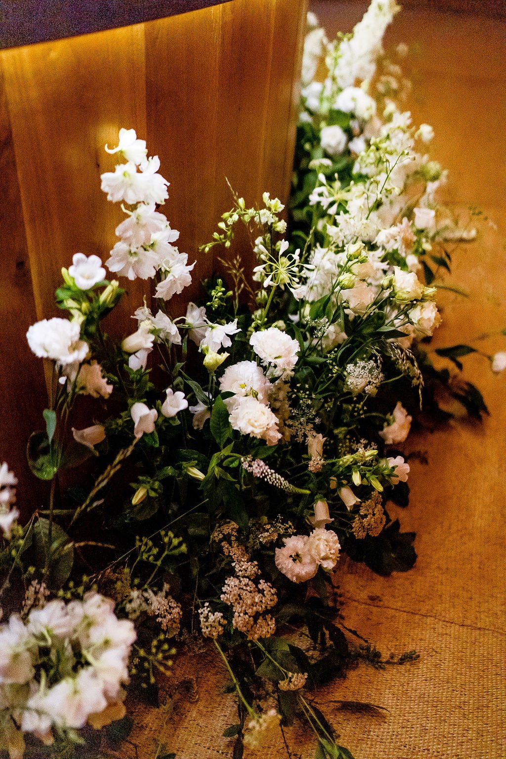 Megan & Lewis Gorgeous PapaKåta Tipi Tent Wedding at Markington Hall, North Yorkshire. Photographed by Joe Dodsworth Photography; Stunning Blooms Around Circular Oak Bar